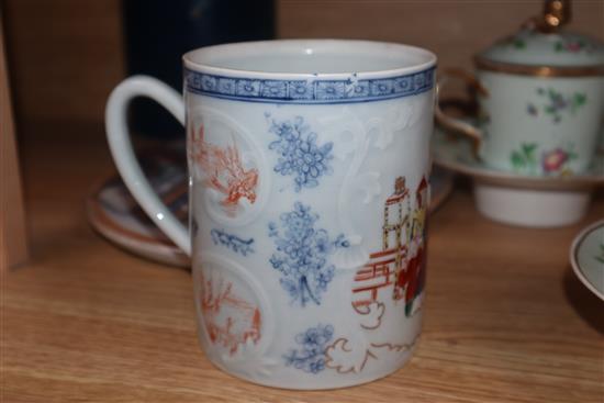 A pair of Paris porcelain chocolate cups, covers and stands, a Samson mug and an ironstone strainer